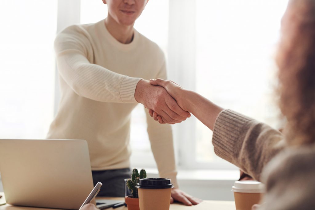 Man Shaking Hands About a 7(a) SBA Loan